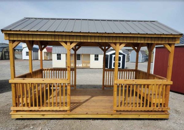 10x16 cabana, charcoal metal roof, spindle railing around outside, two side entry openings, 5/4 decking, two 10ft benches, treated T1-11 siding, water sealed.