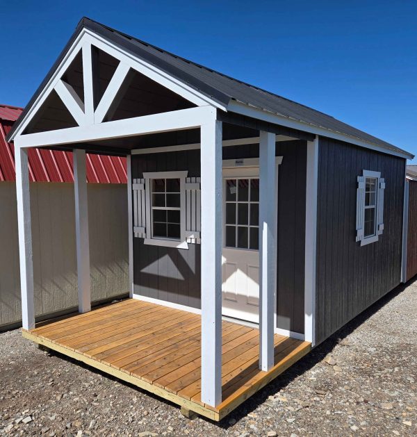 10x20 vertical dormer playhouse utility shed, 7/12 roof pitch, 6in front & back roof overhang, black metal roof, peppercorn walls, barn white trim, 8ft walls, three 2x3 windows with shutters, 6ft porch, wood floor, 60lb snow load, engineer certified.