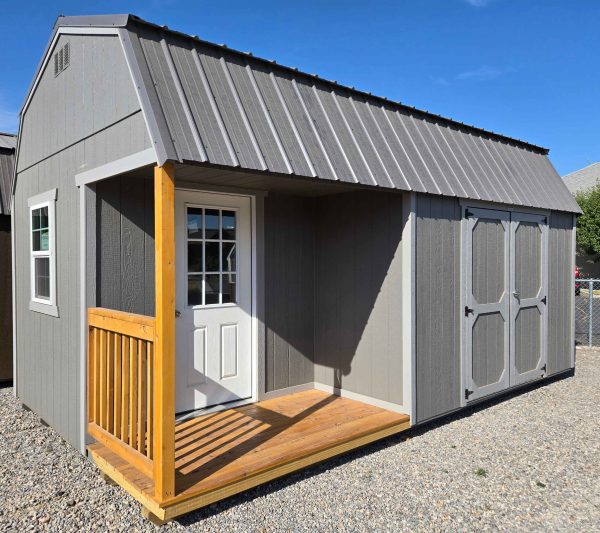 12x20 side porch lofted barn shed, charcoal metal roof, gauntlet gray walls, pewter cast trim, 7ft walls, 12ft of loft, side porch package (two vinyl insulated 2x3 windows, 9-lite house door, porch with railing, double barn doors) wooden floor, 60lb snow load, engineer certified.