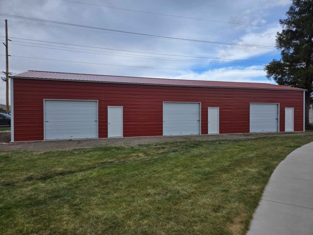 25x75x12 metal garage building. Two inside walls separate the inside into three individual, secure storage spaces. Each storage section includes a walk in door and 10x8 roll up door. Building is rated for a 50lb ground snow load to meet local building requirements.