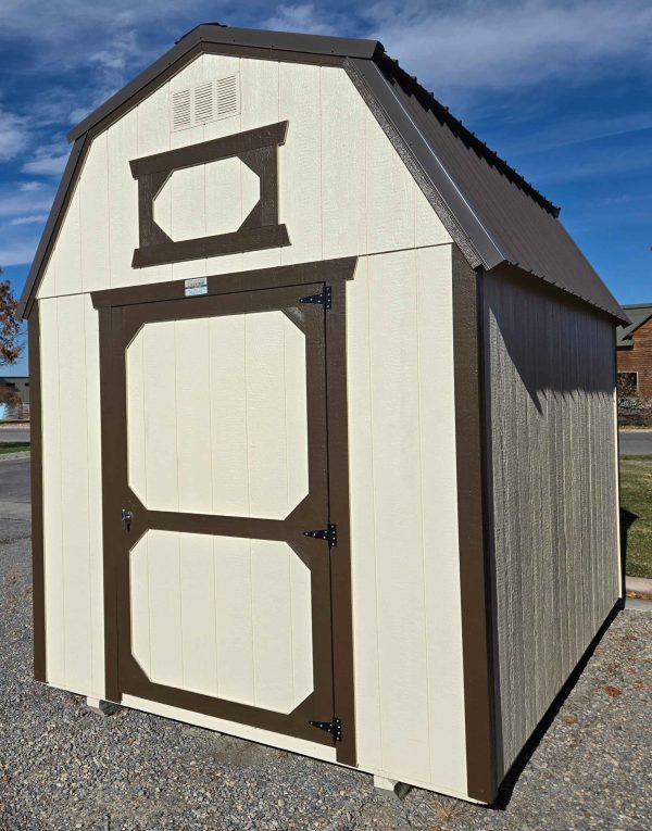 8x12 lofted barn, burnished slate metal roof, eaglet beige color walls, dark clove trim, 7ft tall walls, 4ft single barn door, two 4ft lofts, wood floor, 60lb snow load, engineer certified.