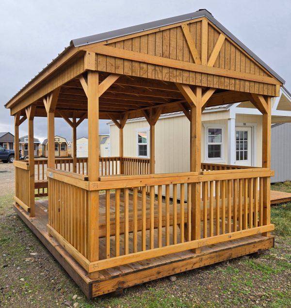 10x16 cabana, charcoal metal roof, spindle railing around outside, two side entry openings, 5/4 decking, two 10ft benches, treated T1-11 siding, water sealed.
