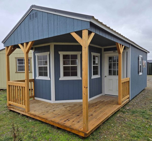 12x28 playhouse utility shed, charcoal metal roof, 7/12 roof pitch, 6in eave overhang front/back, playhouse package, 6ft porch, three 2x3 windows, 9 lite window house door, wooden floor, 8ft tall walls, 60lb snow load, engineer certified.