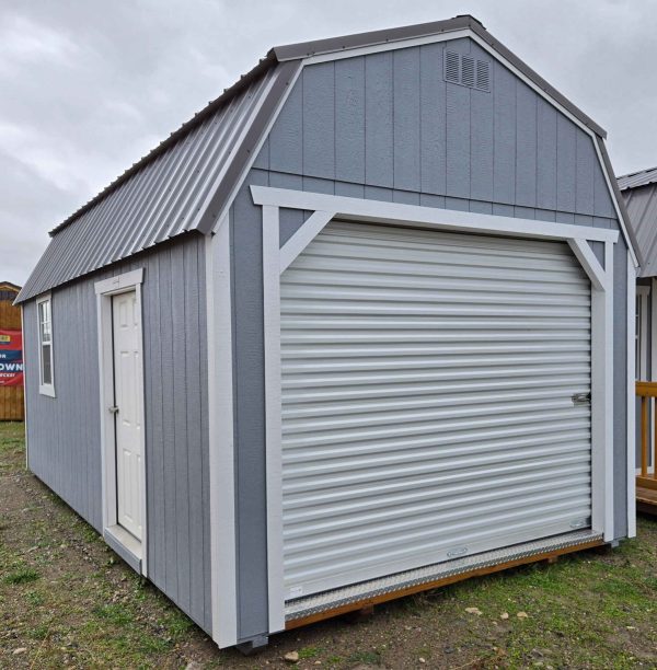12x20 lofted barn garage, charcoal metal roof, steely gray walls, barn white trim, 7ft tall walls, 2x3 window, solid house door, 9'x7' roll up door, two 4ft lofts, wood floor, 60lb snow load, engineer certified.