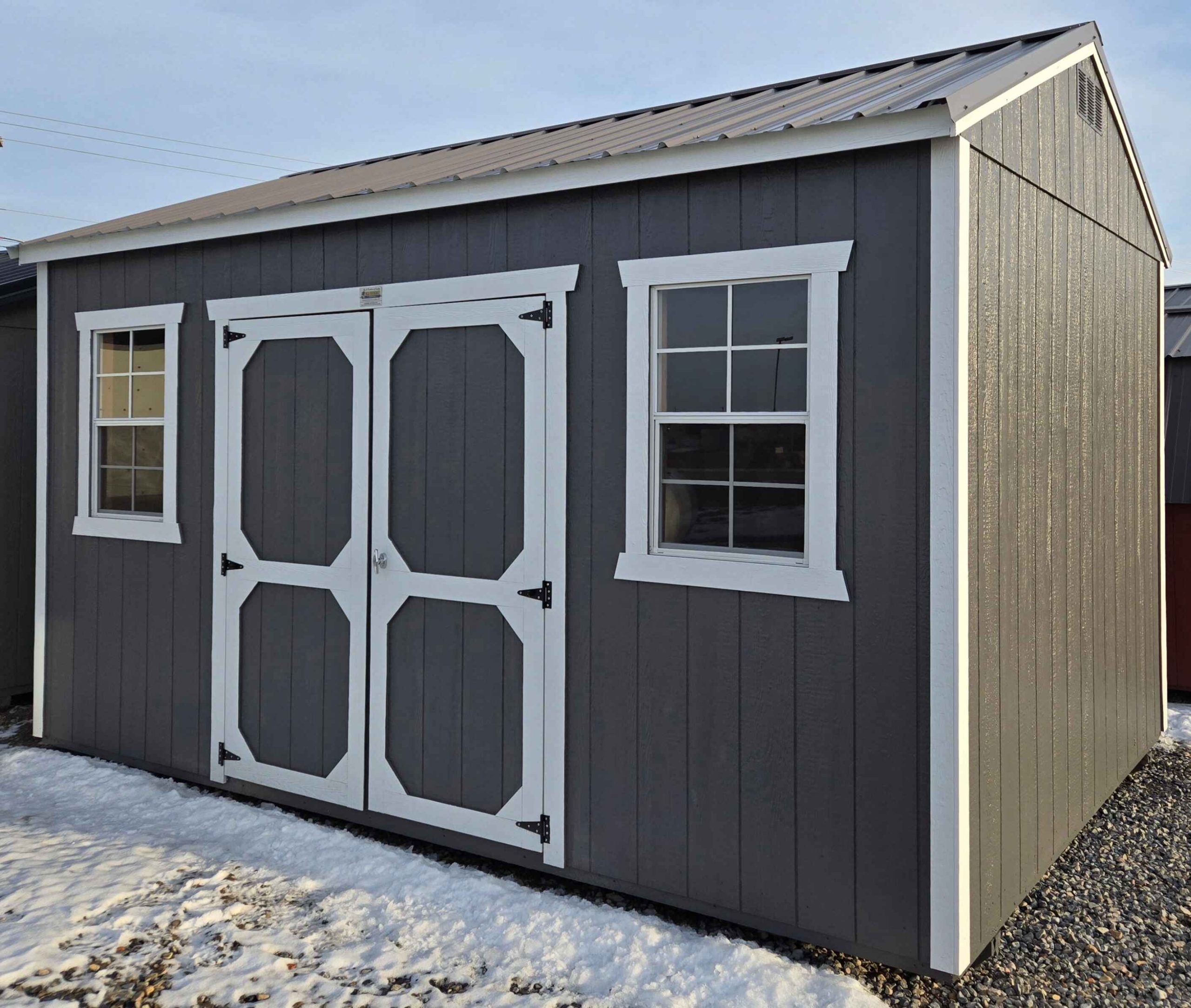 10x16 side utility shed, charcoal metal roof, peppercorn walls, barn white trim, 8ft tall walls, double barn doors, two 2x3 windows, wood floor, 60lb snow load, engineer certified.