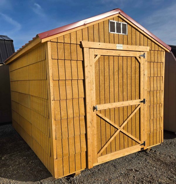 8x12 economy utility, standard 6ft 3in walls, rustic red metal roof, pressure treated T1-11 water sealed siding shake style, 4' single barn door, wood floor, 60lb snow load. As is - no warranty.