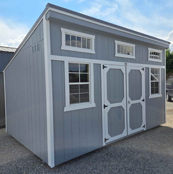 10x16 single slope shed, double barn doors, 3 transom windows, two 2x3 windows, burnished slate metal roof, steely gray walls, barn white trim, wood floor, 60psf snow load, engineer certified.