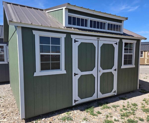 12x15 side utility dormer, rosemary green walls, barn white trim, double barn doors, two 2'x3' windows, roof dormer windows, 7/12 roof pitch, 6" front & back roof overhang, wooden floor, 60lb snow load, engineer certified.